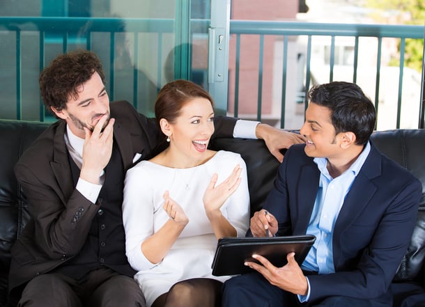 Picture of a manager, financial consultant, banker presenting to young smiling married couple, business investment opportunity plan, isolated on background of city buildings. Finance smart decisions.